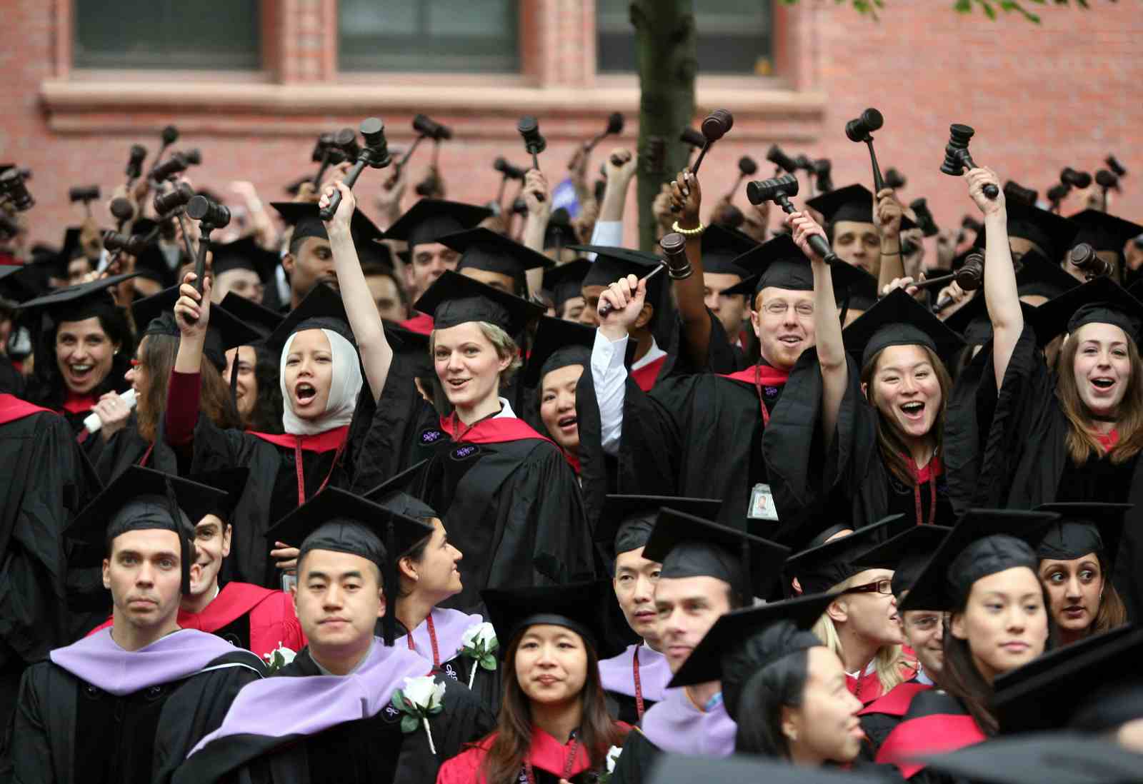 Graduating Harvard University Law School students stand and wave gavels (Robert Spencer/Getty Images)