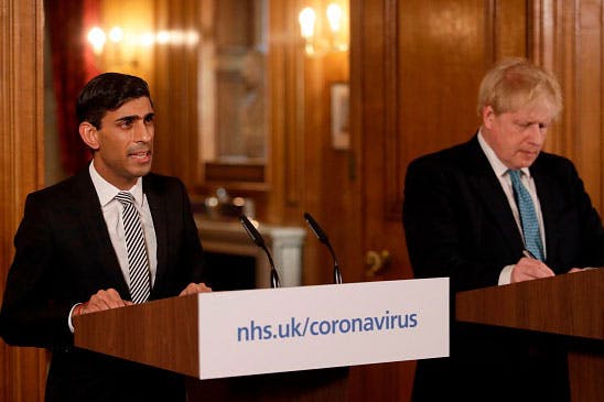 Britain's Chancellor of the Exchequer Rishi Sunak (left) speaks beside Prime Minister Boris Johnson at a news conference addressing the government’s response to the COVID-19 outbreak, on March 17, 2020. (Matt Dunham/Pool/AFP via Getty Images)