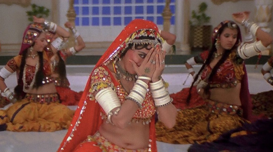 The song's visuals feature a charming Dixit, donning a Rajasthani folk lehenga, almost bridal gold and red ('Khalnayak', a 1993 film by Subhash Ghai)