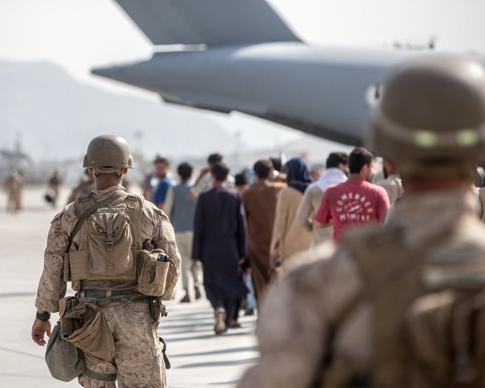 U.S. Marines guide evacuees on to a Boeing C-17 Globemaster III during an evacuation at Hamid Karzai International Airport, Kabul, Afghanistan, Aug. 21 (U.S. Marine Corps photo by Sgt. Samuel Ruiz)