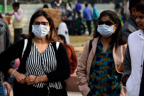 People wear mask following the coronavirus scare in New Delhi, India on February 1, 2020. (Photo by Muzamil Mattoo/NurPhoto via Getty Images)