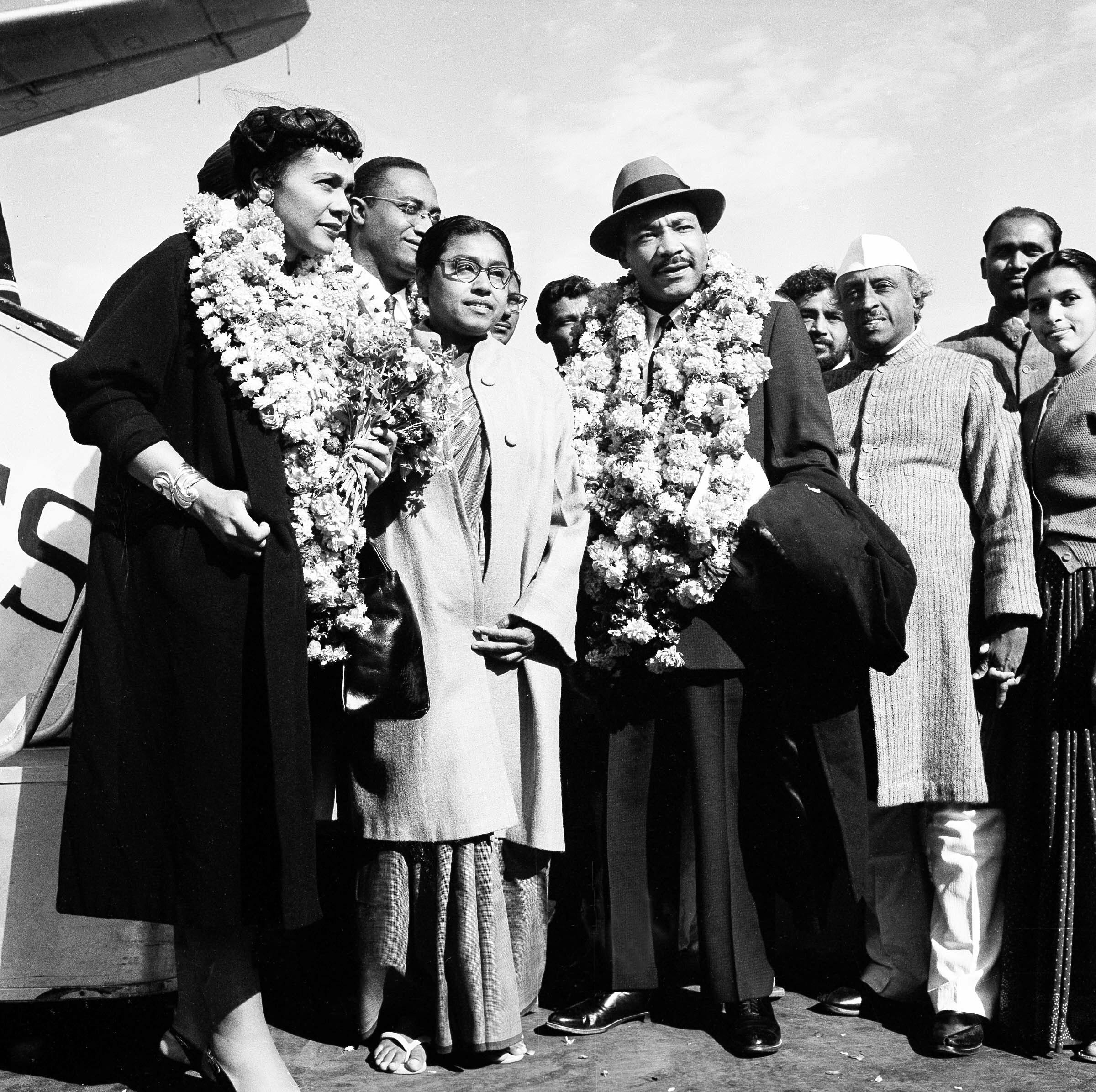 American civil rights leader Rev. Dr. Martin Luther King, Jr. and his wife Coretta, both wearing garlands, are received by admirers after landing at the airport in New Delhi, India, Feb. 10, 1959. King, who is known in the U.S. as the American Gandhi, flew to India on what he calls a "four-week pilgrimage in India which to me means Mahatma Gandhi." (AP Photo/Rangaswamy Satakopan)