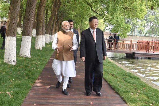 Indian Prime Minister Narendra Modi and Chinese President Xi Jinping walk together in Wuhan, China, in April 2018. (India Press Information Bureau)