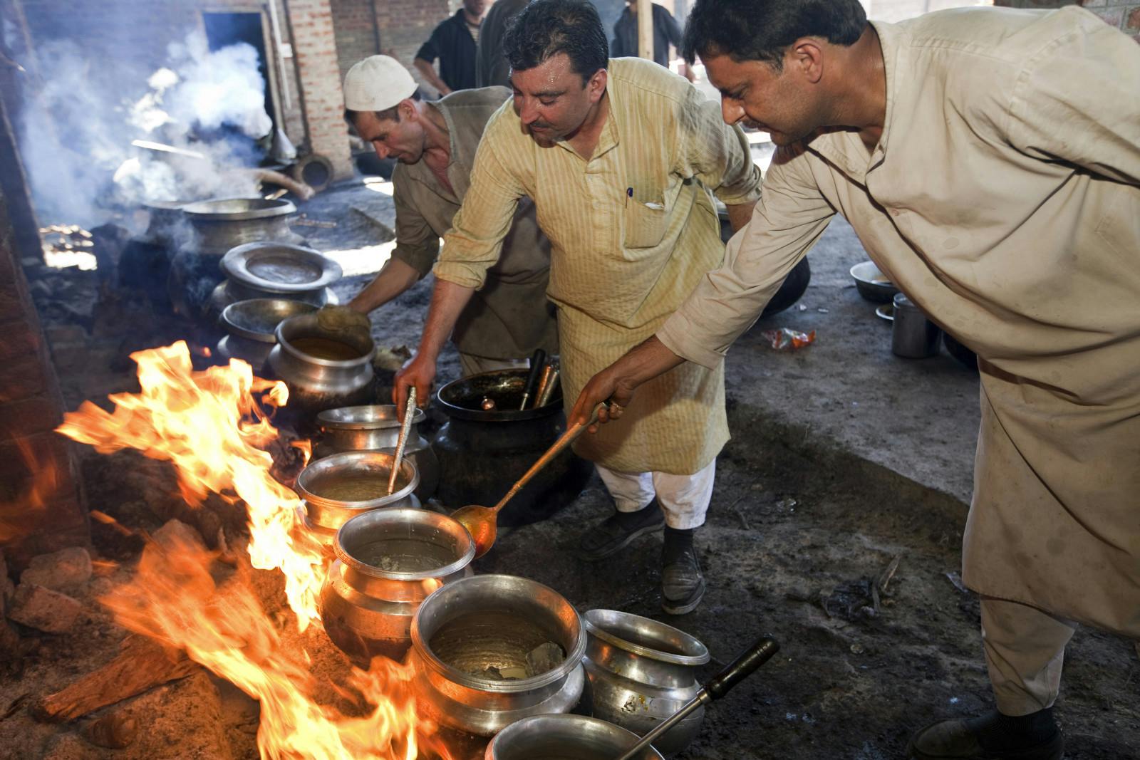 Khan Mohammed Sharief Waza, a traditional Kashmiri chef (center) cooks at a wazwan feast. Srinagar, Kashmir, India (Pictures Ltd./Corbis via Getty Images)