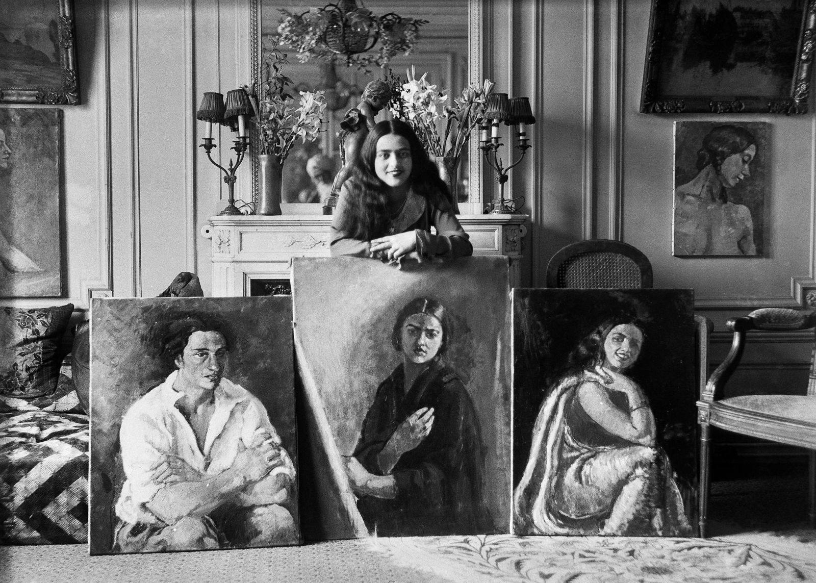 Amrita Sher-Gil with her paintings (Umrao Singh Sher-Gil reflected in the mirror), Paris, France, c.1930 (The Sher-Gil Archives)
