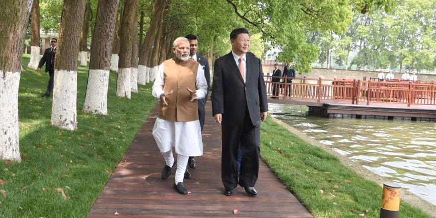 Indian Prime Minister Narendra Modi and Chinese President Xi Jinping walk together in Wuhan, China, in April 2018. (India Press Information Bureau)