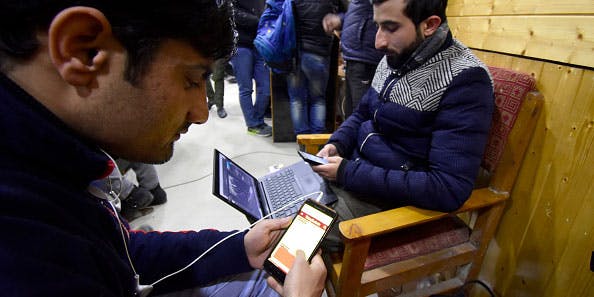 Kashmiris use their devices after authorities restored low-speed mobile internet services in Kashmir in January 2020. (Muzamil Mattoo/NurPhoto via Getty Images)