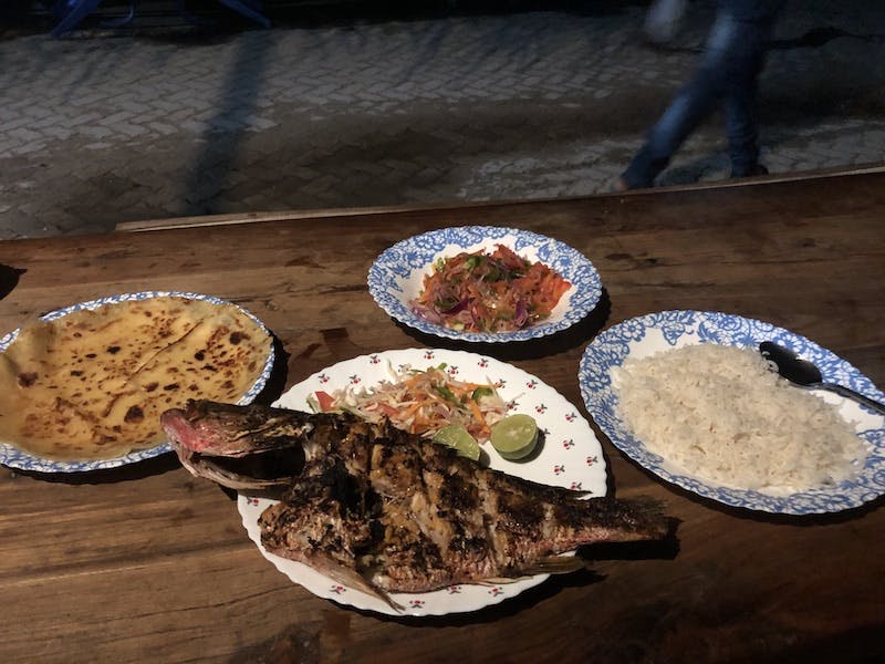 Grilled fish, rice, chapati, and kachumbari. (Dur e Aziz Amna) 