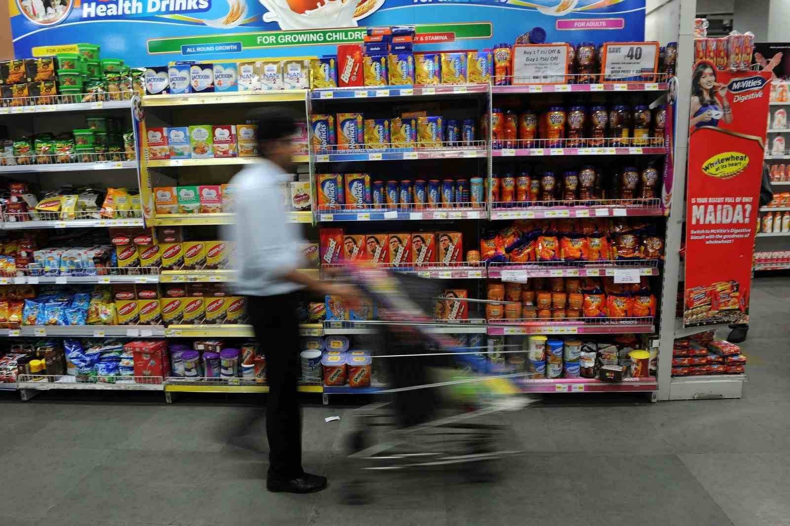 An Indian shopper browses at a supermarket in Mumbai in front of an aisle full of chocolate malt drinks such as Horlicks, Bournvita, Boost, etc. (INDRANIL MUKHERJEE/AFP via Getty Images)