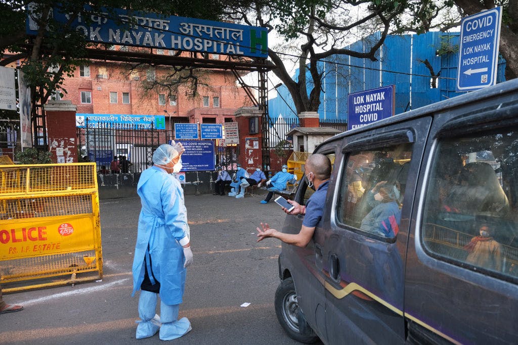 Health workers turn away a vehicle at the main entrance of the Lok Nayayak Jaiprakash Hospital in Delhi on Sunday, April 25, 2021 (T. Narayan / Bloomberg via Getty)