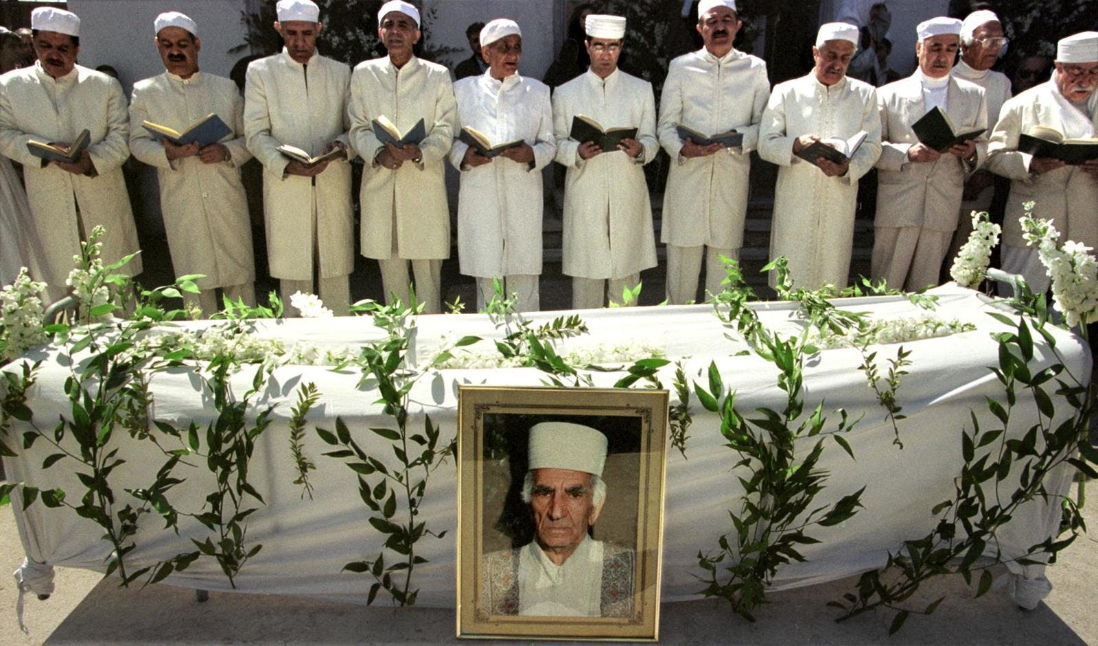 Zoroastrian priests pray for the religious leader of the Iranian Zoroastrian community Dastur Rostam Dinyar Shahzadi during his funeral in Tehran on March 15, 2000 at the Zoroastrian Qasr-e-Firoozeh cemetery.(HENGHAMEH FAHIMI/AFP via Getty Images)