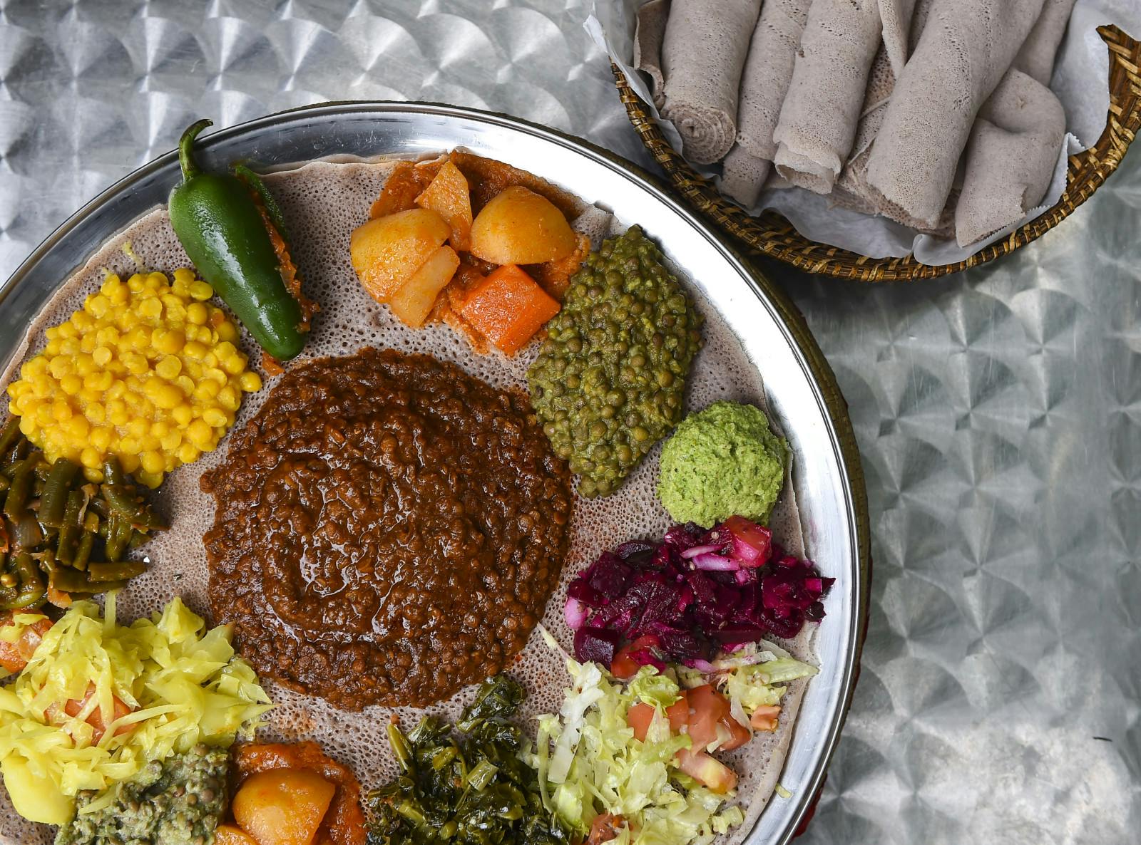 red lentils, brown lentils, jalapeños, beets, collard greens, potatoes, carrots, azifa, cabbage, green beans, split peas served with injera at Bete Ethiopian Cuisine and Cafe, Silver Spring (Ricky Carioti/The Washington Post via Getty Images)